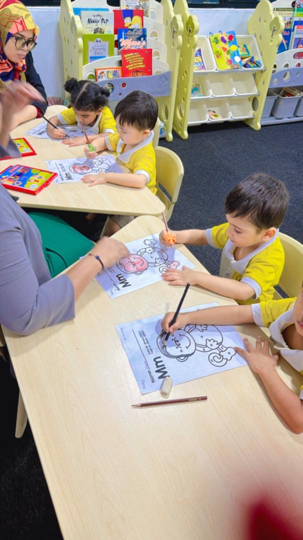 Children doing finger painting and creative arts in nursery